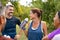 Thirsty mature woman drinking water after workout