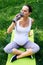 Thirsty pregnant woman drinking water after yoga workout