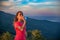 Thirsty woman trail runner drinking water from water bottle.