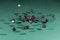 Thirty black dices falling on a green table