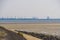 Tholen beach with view on the industrial zone, Bergse diepsluis, Oosterschelde, Zeeland, The Netherlands