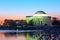 Thomas Jefferson Memorial and Capitol Building at predawn during cherry blossom festival.