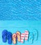 Thongs on the blue planks against blue water