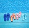 Thongs on the blue planks against blue water