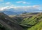 Thorsmork valley with green vegetation of moss, fern, birchwood under blue sky in sunny summer day, Iceland