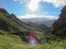 Thorsmork valley with green vegetation of moss, fern, birchwood under blue sky in sunny summer day, Iceland