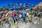 Thorung La Pass - A couple standing between prayer flags on top of the pass