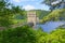 Though dense foliage to Howden Dam on a nazy summer day