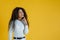 Thoughtful African American woman. studio shot with yellow background