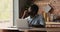 Thoughtful African man studying learning online use laptop