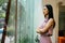 Thoughtful Asian businesswoman looking out of window in modern office