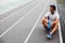 Thoughtful athlete drinking bottle of water outdoor