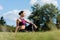 thoughtful athletic woman sitting on grass