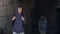 Thoughtful black teen in hoodie with backpack walking dangerous city suburb