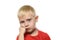 Thoughtful blond boy in a red T-shirt worth placing fist under his cheek. Portrait. Isolate on white background