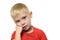 Thoughtful blond boy in a red T-shirt worth placing fist under his cheek. Portrait. Isolate on white background