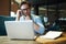 Thoughtful boss concentrated on checking accountings on laptop.