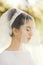 Thoughtful bride closes her eyes while she stands in the morning
