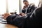 Thoughtful businessman sitting at his desk with partner