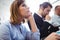 Thoughtful businesswoman with coworkers in meeting room