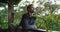 Thoughtful caucasian man standing on balcony admiring the countryside view