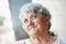 Thoughtful elderly woman portrait on a light background