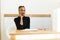 Thoughtful elegant African or black American businesswoman at desk in office