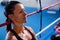 Thoughtful female boxer leaning on rope