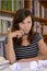 Thoughtful female student on desk