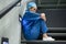 Thoughtful female surgeon sitting on staircase