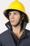 Thoughtful fireman looking away against gray background