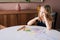 Thoughtful girl thinking about what picture do drawing with colorful pencil at the table i