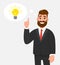 Thoughtful happy businessman pointing up to the bright bulb in the thought bubble. Idea, innovation, invention,problem solving, s.