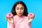 Thoughtful hungry woman choosing between donuts