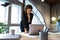 Thoughtful Indian businesswoman executive touching chin, looking at laptop screen