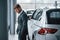 Thoughtful look. Modern stylish bearded businessman in the automobile saloon