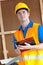 Thoughtful male worker holding a clipboard