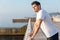 Thoughtful man athlete standing in pier in the morning