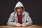 Thoughtful man with hooded shirt sitting at desk