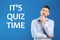 Thoughtful man and phrase IT`S QUIZ TIME on blue background