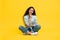 Thoughtful Middle Eastern Woman Thinking Sitting Over Yellow Background