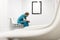 Thoughtful nurse in uniform sitting on chair at hospital corridor