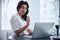 Thoughtful physician seated at the desk in her office