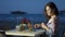 Thoughtful pretty female enjoying cocktail at seaside restaurant, romantic mood