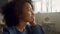 Thoughtful pupil sitting in classroom. African girl boring during lesson