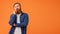 Thoughtful redhaired bearded businessman in casual thinking against orange background