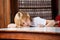 Thoughtful Schoolboy Leaning On Table In Library