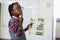 Thoughtful schoolboy using a maths abacus in classroom