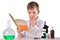 Thoughtful science boy reads book at chemistry lab at the desk