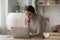 Thoughtful serious freelance worker woman working from home kitchen